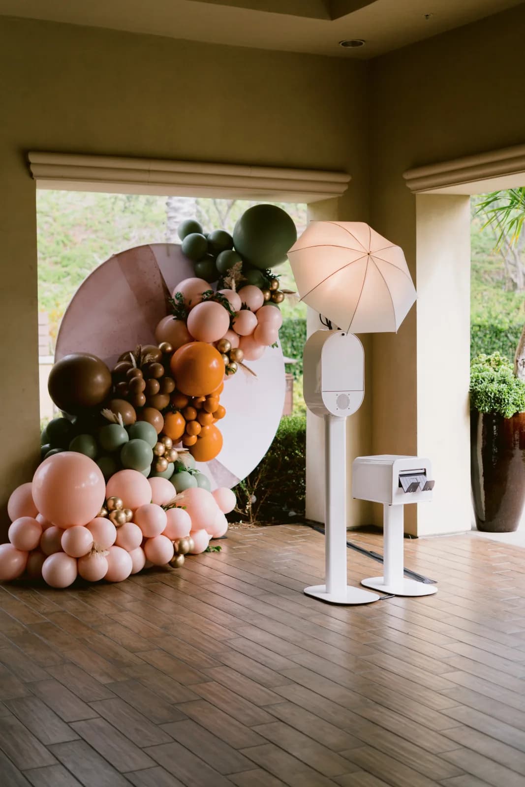 Honey Photobooth with a balloon backdrop at an event