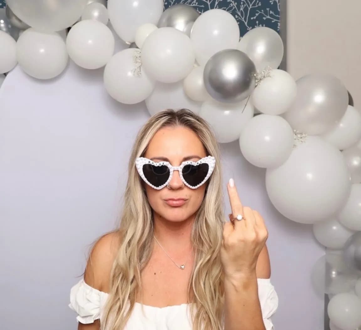 Bridal shower guest posing with novelty sunglasses