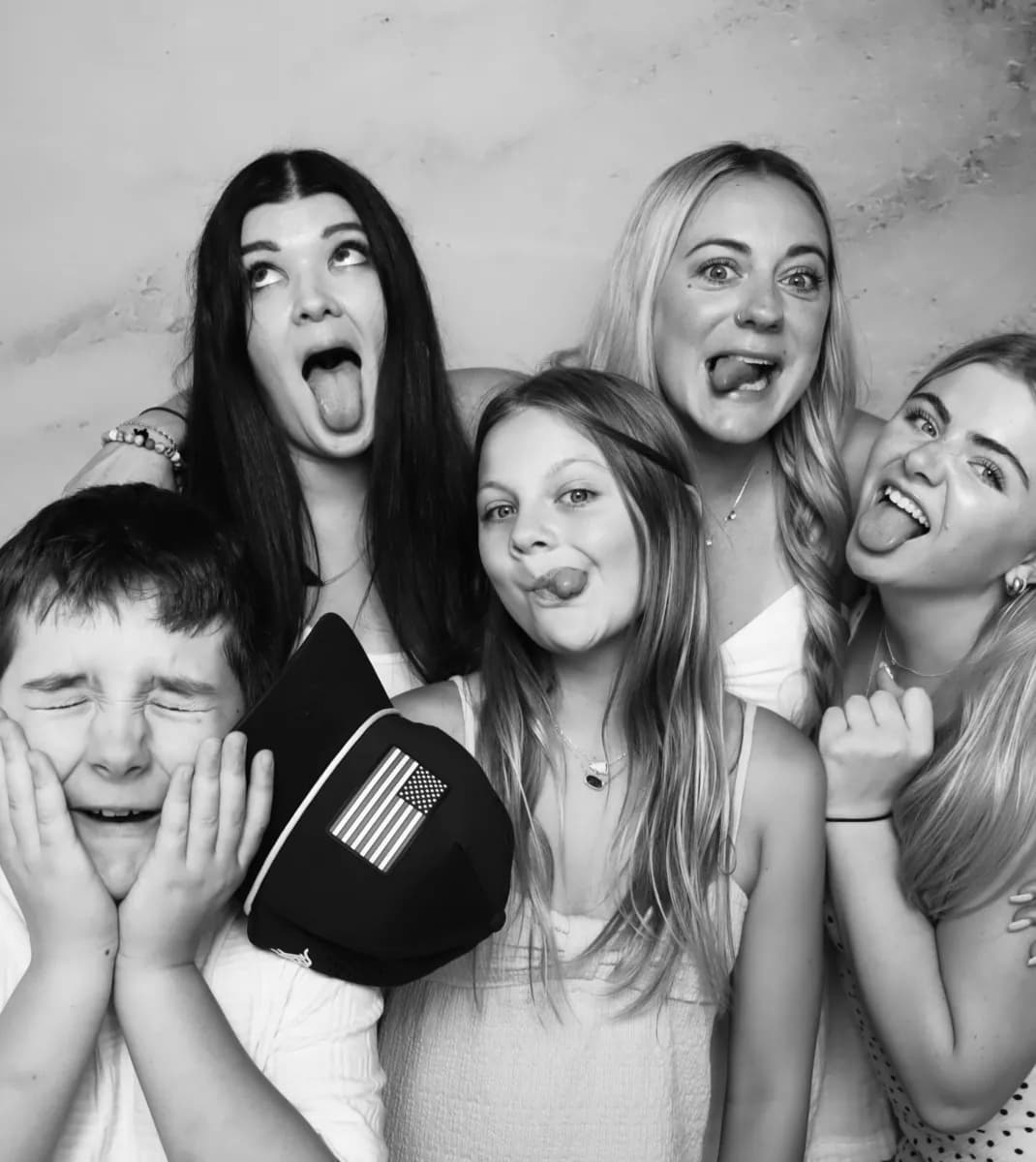 Friends posing for a black-and-white photo booth picture