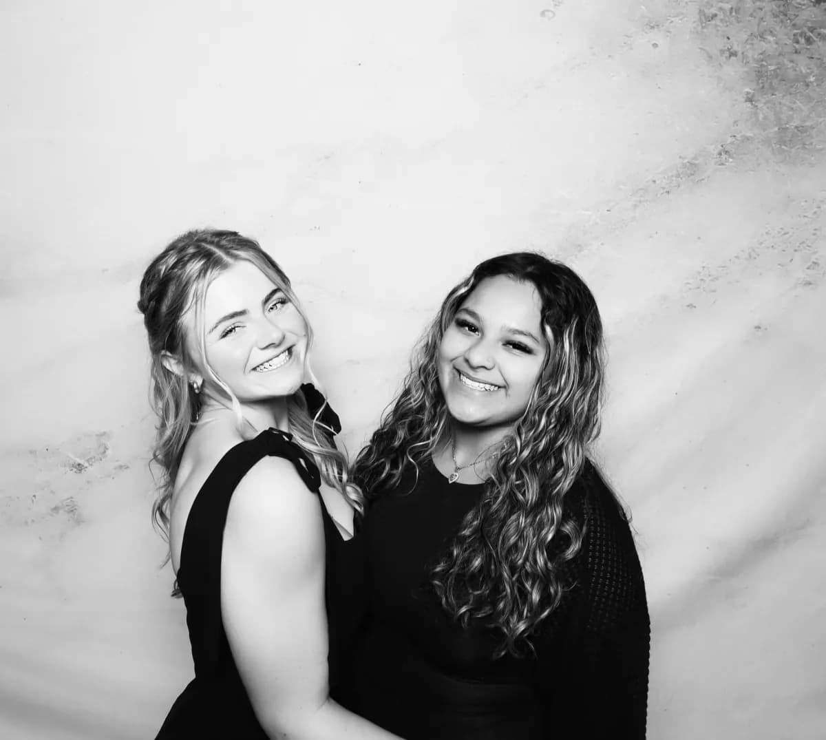 Two friends posing for a black-and-white portrait