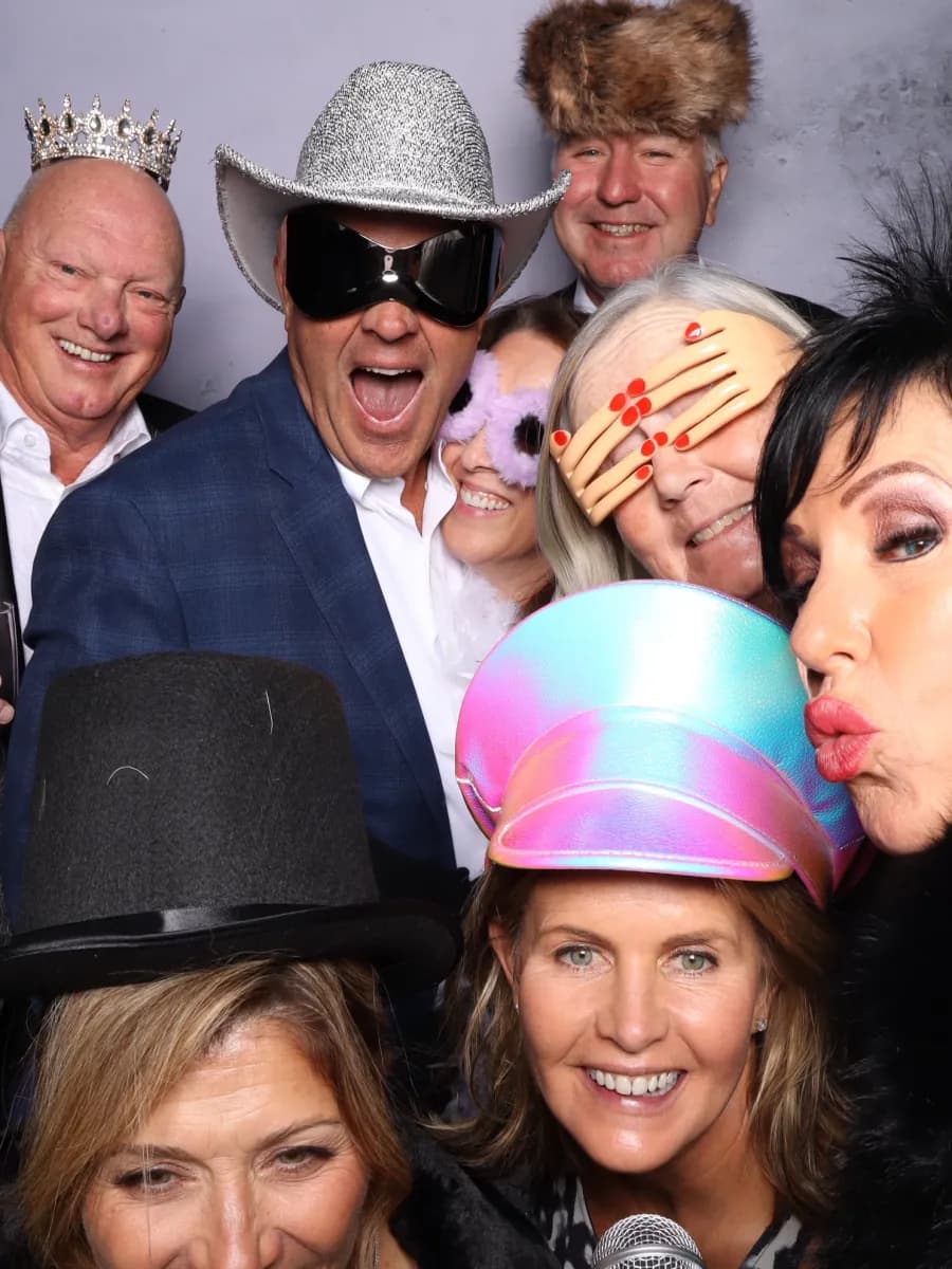 Party guests wearing playful photo booth props
